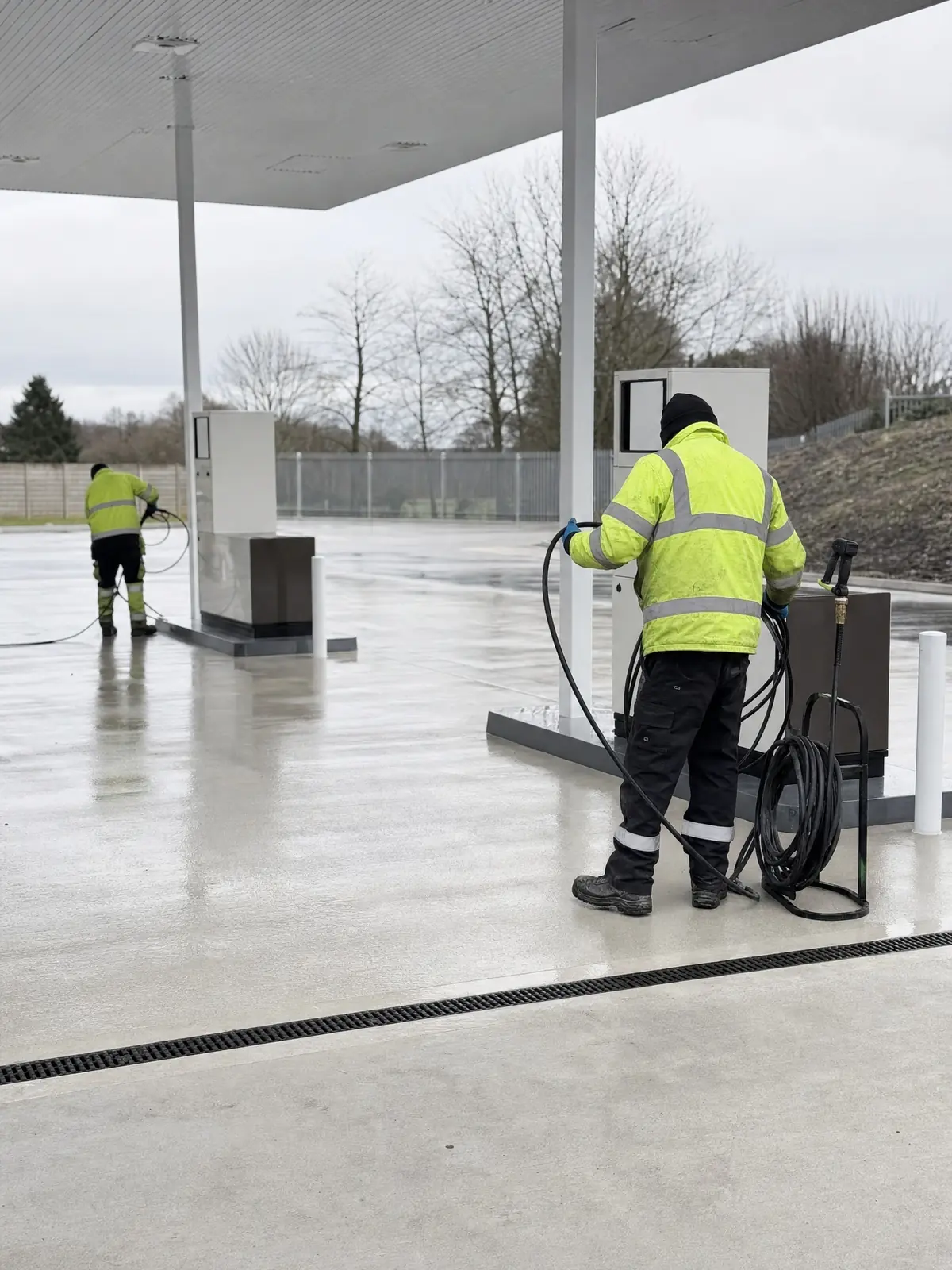 A finished clean forecourt with equipment being packed away